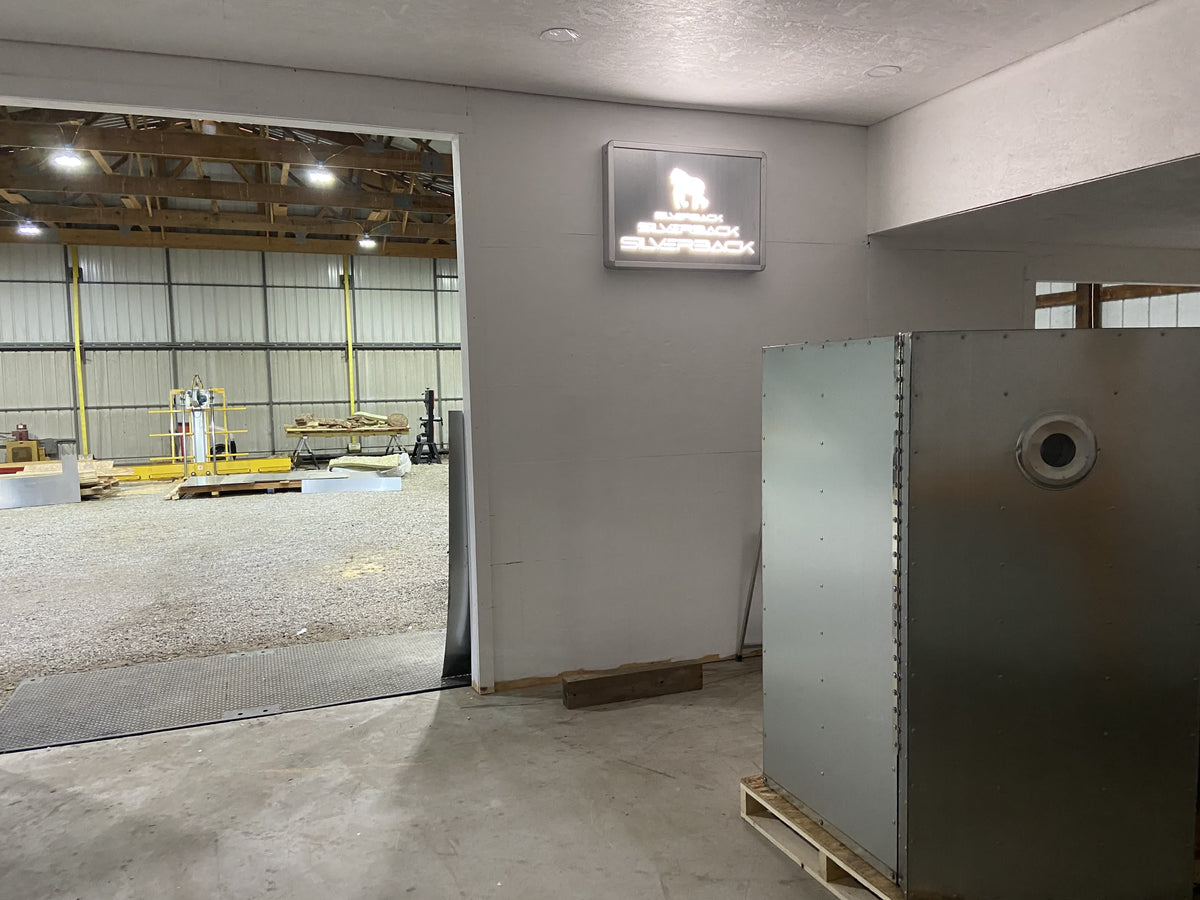 Inside the Silverback shop, lit sign over the office wall with an oven staged in front