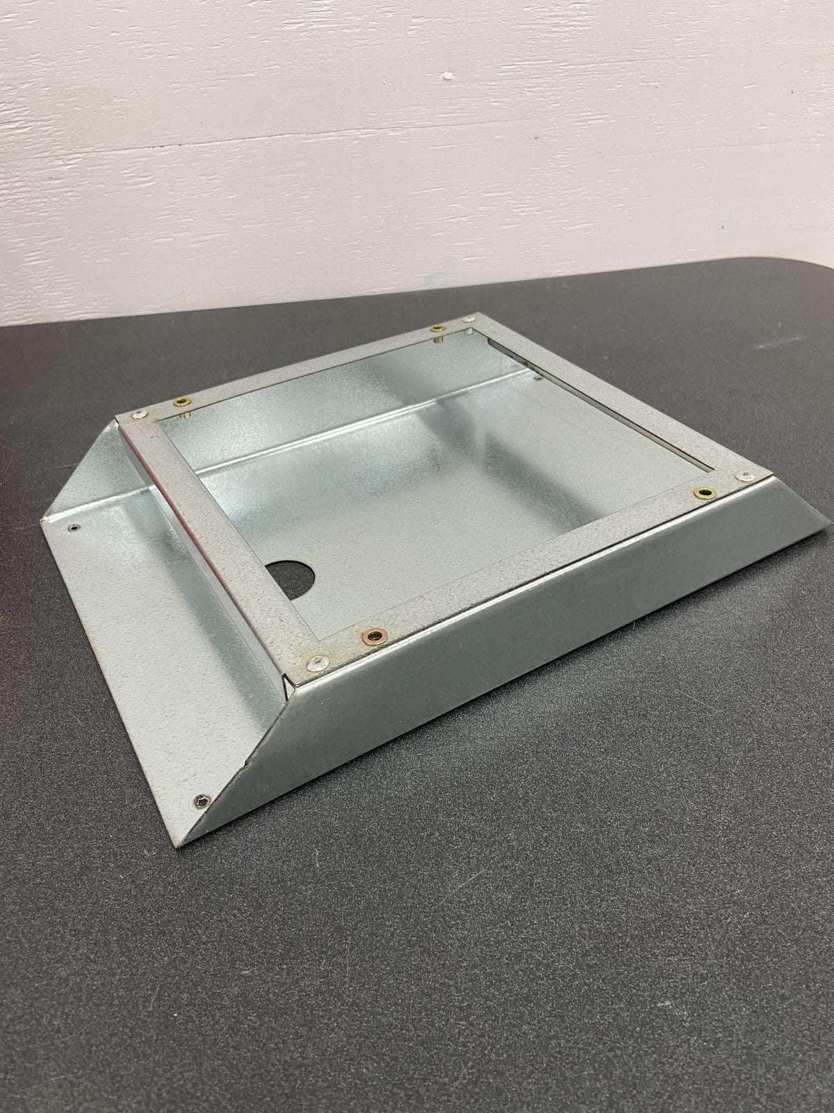 The included mounting bracket, holding the box off the hot surface