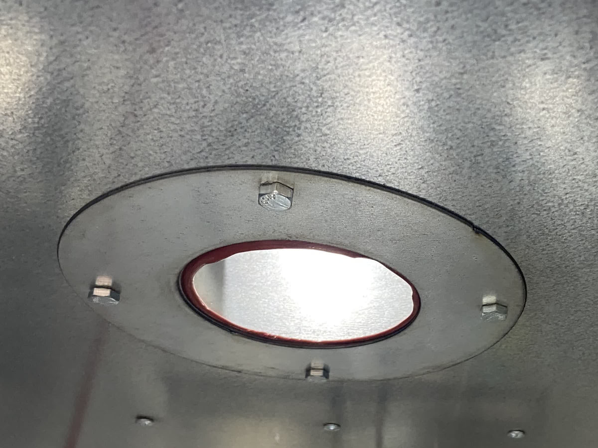 Recessed interior light lit and flush in the oven ceiling