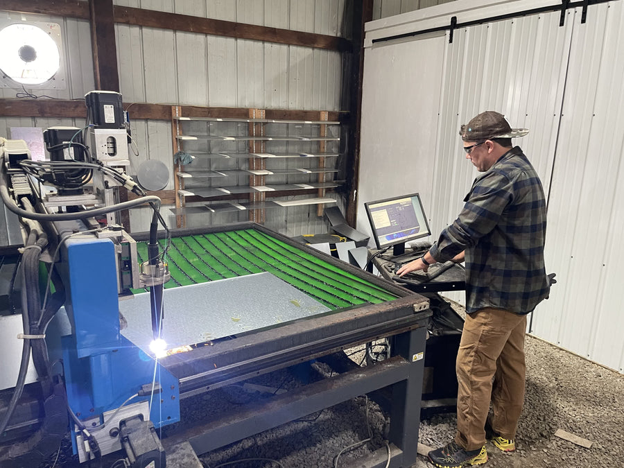 Andrew on the plasma table, cutting oven panels