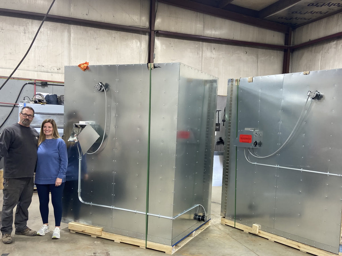 A customer couple next to their new Silverback oven, delivered to their shop